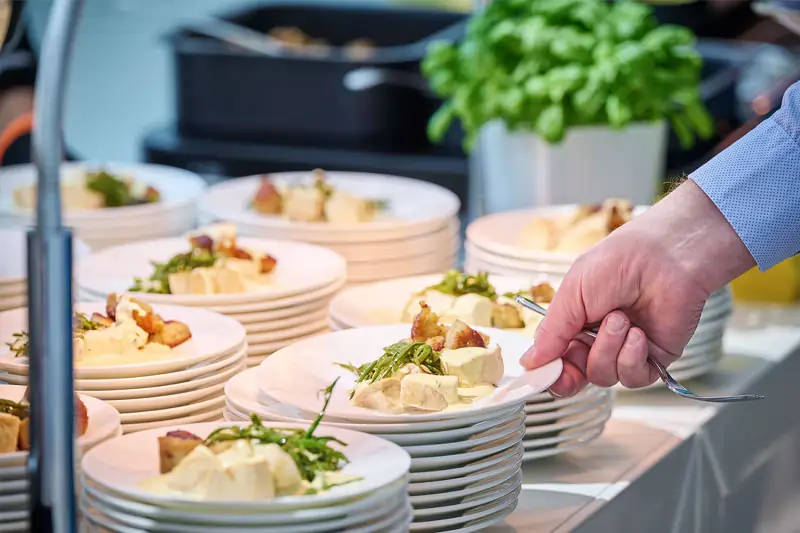 Gastico Buffet, ein Gast nimmt sich einen Teller